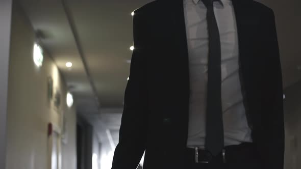 Businessman Walking with Luggage in Hotel