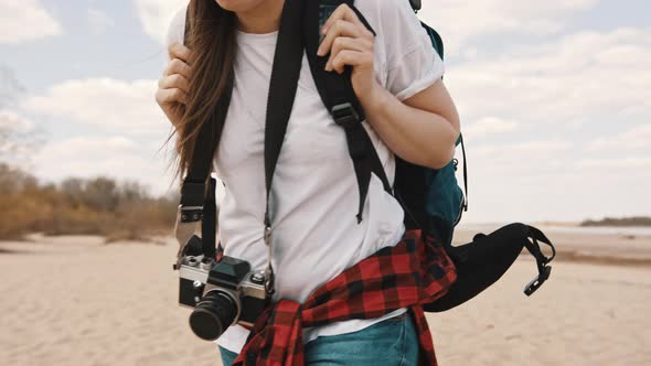 Young Woman Backpacker Walking Along the Sandy Beach. Close Up No Face