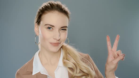 Young Business Woman Showing v Sign. Smiling Businesswoman Show Peace Sign