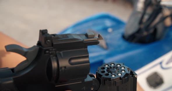Men Hands Close Up Refilling Air Gun Revolver Outdoors