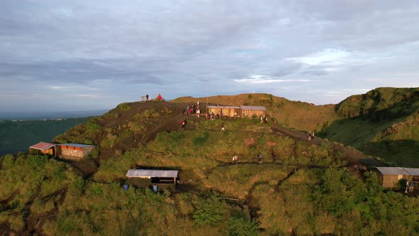 aerial dolly zoom out of coffee huts on a volcano rim in Bali Indonesia