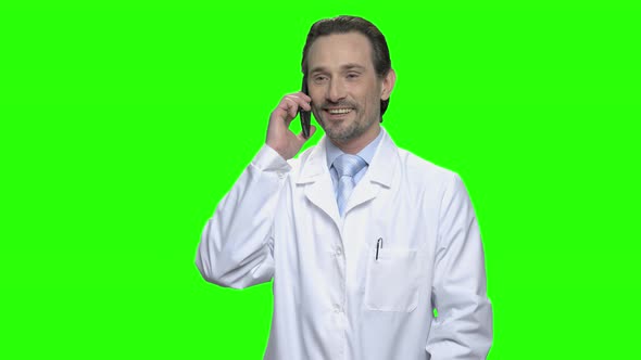 Positive Smiling Male Doctor Talking on Phone