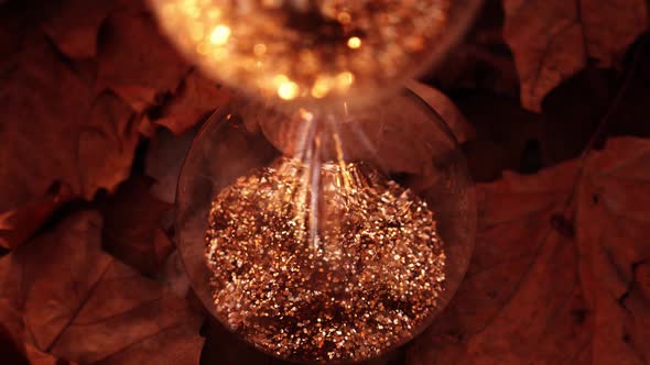 Hourglass Filled Golden Sparkles Stands Dry Leaves