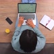 Overhead View of Multiracial Freelancer Sitting at the Floor and Typing on the Laptop - VideoHive Item for Sale