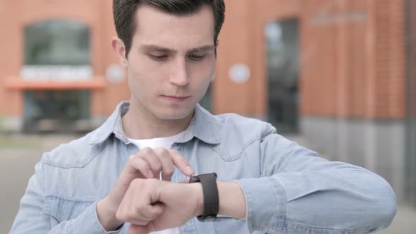 Young Man Using Smartwatch Outdoor