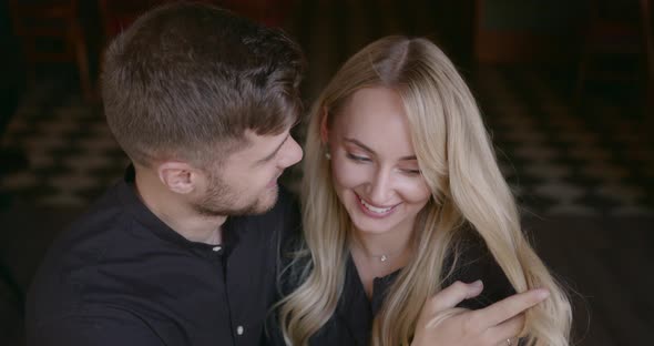 Beautiful People Man and Woman Hugging at Restaurant