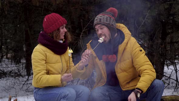 Young Man and Woman on a Picnic in the Winter Forest