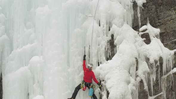 Ascending aerial Ice climbers scale cascade at Mount Kineo, Maineline