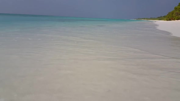 Aerial flying over sky of tropical lagoon beach lifestyle by blue ocean and clean sand background of