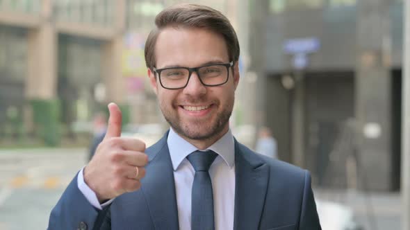 Portrait of Businessman showing Thumbs Up Sign
