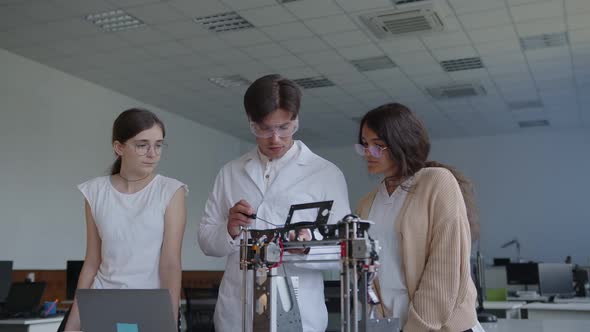 Explanation of Young Teacher in Goggles and Two Students