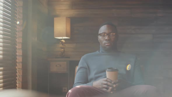 Portrait of Afro-American Man Sitting with Coffee Cup