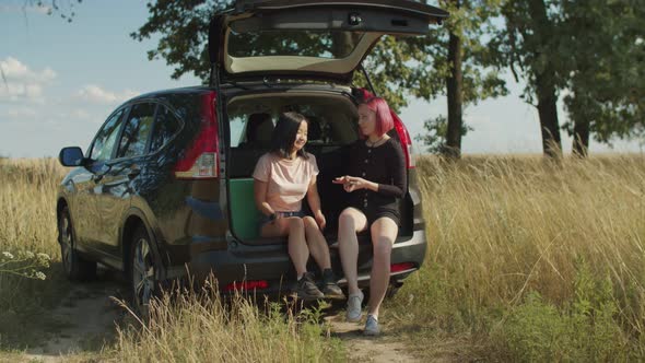 Relaxed Females Playing Cards During Road Trip