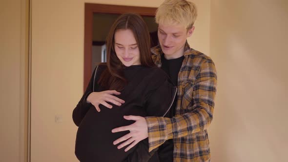 Happy Teenage Couple Standing at Home Together