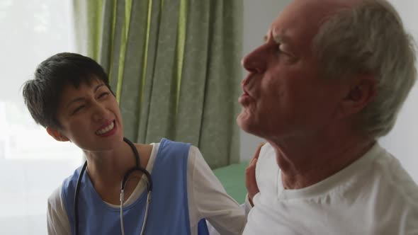 Nurse helping a senior man in retirement house