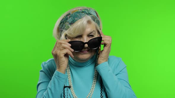 Elderly Stylish Caucasian Grandmother Woman Talking on Mobile Phone. Chroma Key