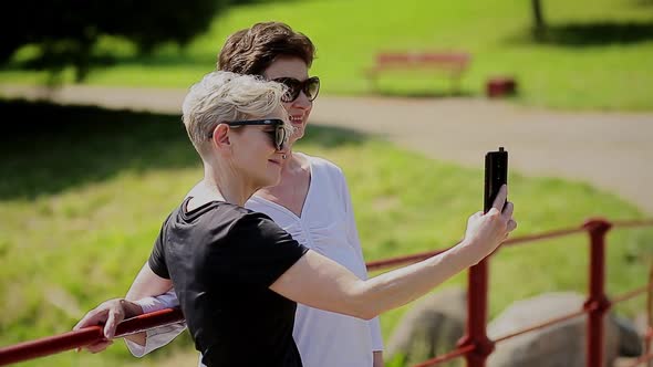 Cheerful Senior Women Couple Having Fun Take a Selfie in the Phone