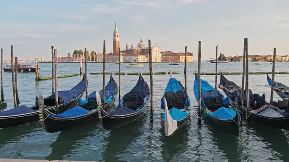 Docked Empty Gondolas on Wooden Mooring Piles Venice Italy