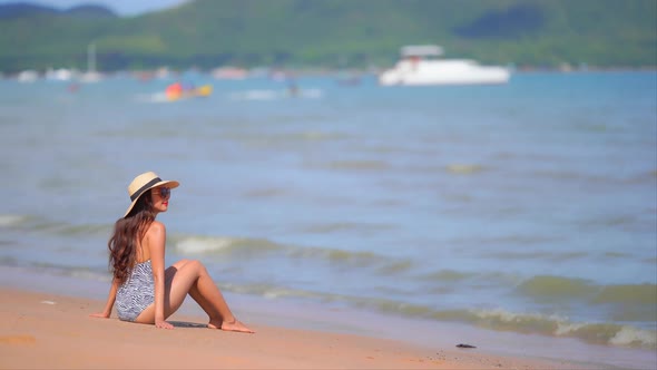 Asian woman enjoy around beautiful beach sea ocean