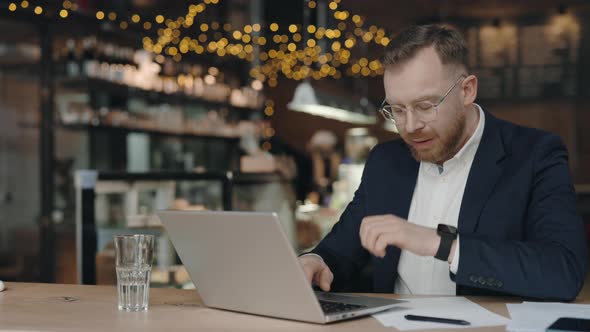 Businessman Coughing While Working at the Cafe