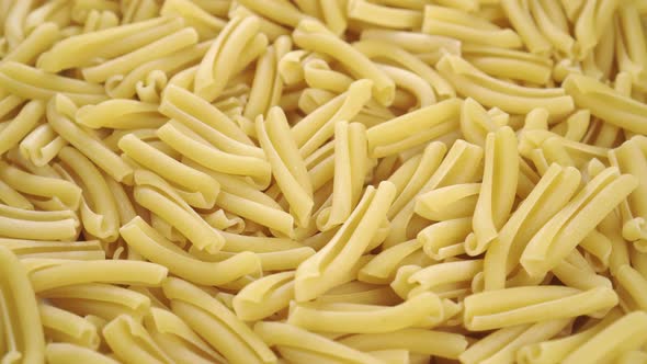 Raw yellow casarecce pasta. Italian traditional uncooked macaroni