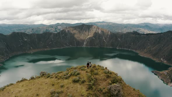 Tourists Enjoying Scenic View Of Quilotoa Lake In Ecuador - aerial drone shot