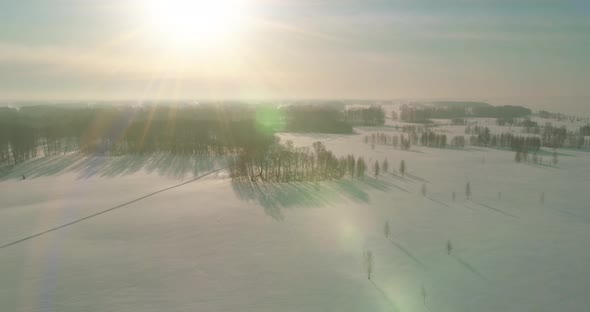 Aerial View of Cold Winter Landscape Arctic Field Trees Covered with Frost Snow Ice River and Sun