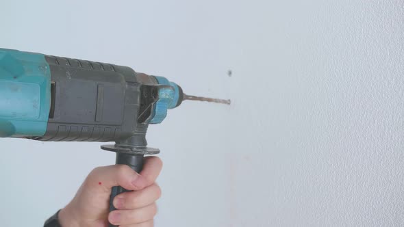 Man Hands Technician Worker Use Electric Drill To Drilling The Wall