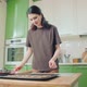 Young Caucasian Woman Cuts Out Cookies From a Dough at Home Kitchen - VideoHive Item for Sale