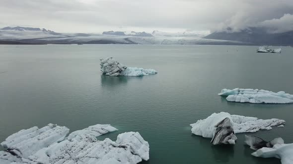 A drone footage of jokulsarlon glacier lagoon with a tourist boat