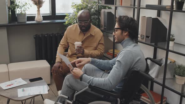 Male Colleagues Working with Documents