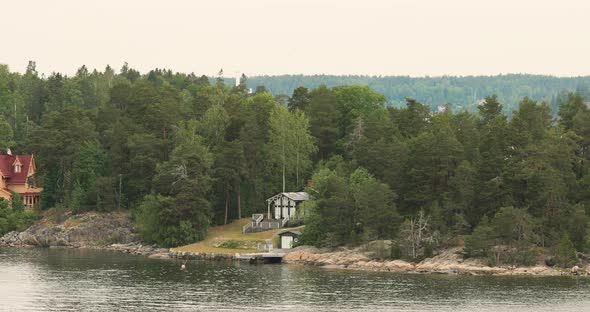 Swedish Wooden Sauna Log Cabin House On Island Coast In Summer Cloudy Day