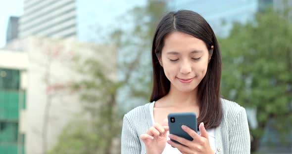 Woman use of cellphone for online at outdoor