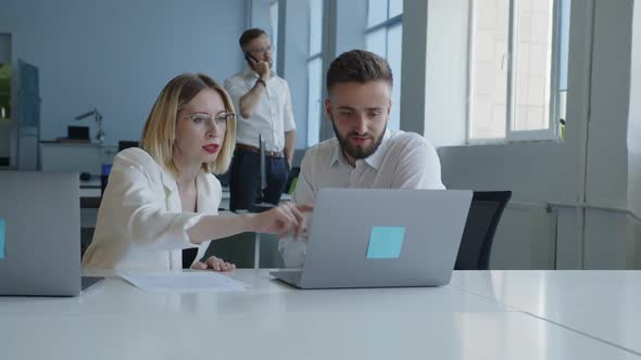 Coworkers Do Their Work Together in an Office