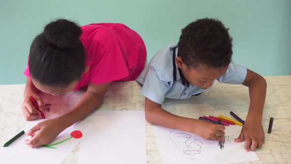 African American Kids Learning How to Draw with Crayon on Table