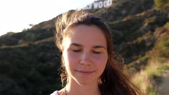 Beautiful Young Woman Portrait with Windy Hair Blinking Eyes Peace