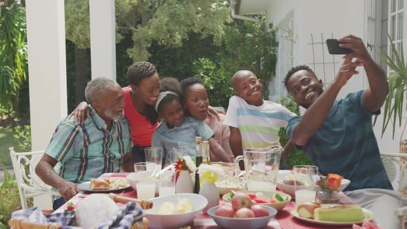 Happy family eating together at table