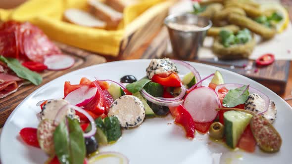 Greek salad served on table in Mediterranean restaurant for lunch