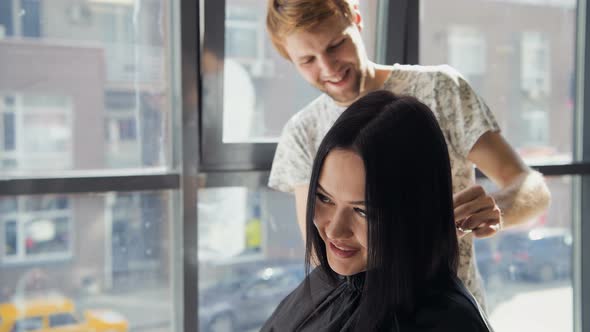 Hairdresser Creating a Hairstyle for Beautiful Woman Closeup