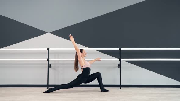 Woman Stretching Leg in Reverse Lunge Holding Handrial