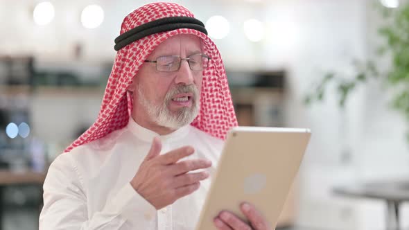 Senior Old Arab Businessman Doing Video Call on Digital Tablet 