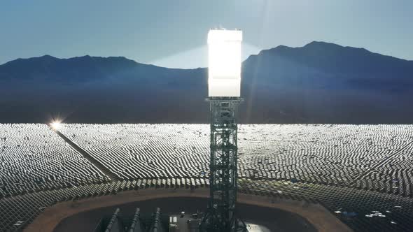 Cinematic View on Tall Solar Tower with Huge Mirror Panel Accumulating Sun Rays