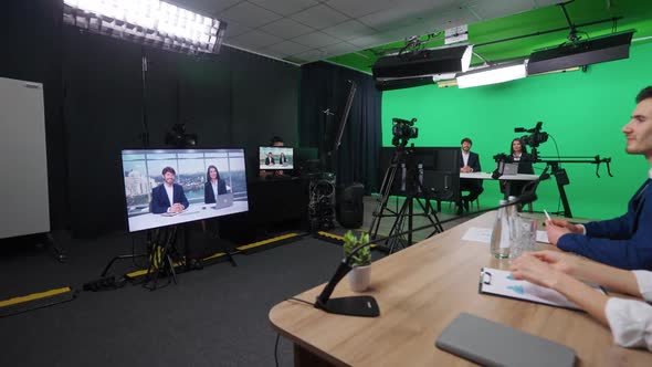 Multicam Live Broadcast News Anchors at Work View of a Backstage Studio TV News Shooting Chroma Key