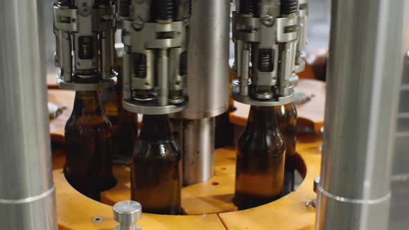 The process of screwing the cork on glass bottles