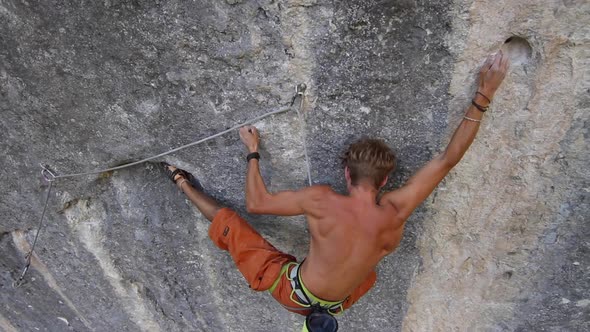 A man rock climbing up a mountain.