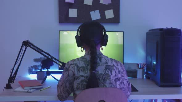 Teenage Girl Playing Shooter Game on Computer