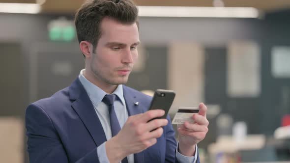 Portrait of Businessman Making Online Payment on Smartphone