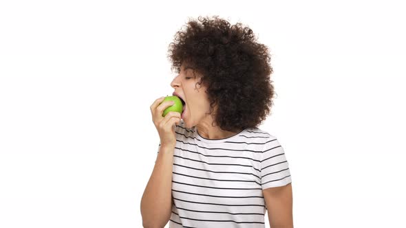 Halfprofile Portrait of Happy Woman Wearing Casual Clothes Being Hungry Eating Green Juicy Apple