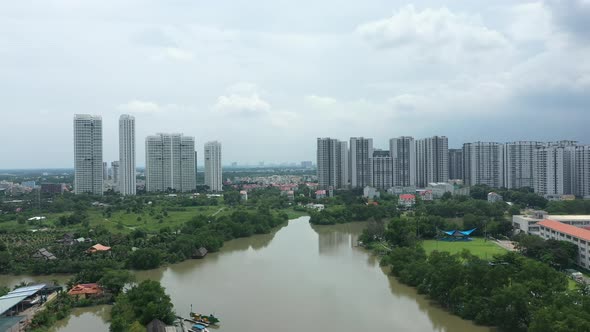 rising drone shot flying over river with ultra modern residential high rise developments featuring i