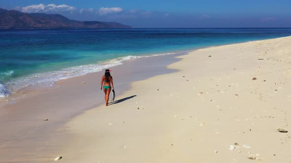 Pretty happy ladies travelling by the sea on beach on paradise white sand and blue background 